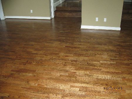 Moisture-protected hardwood floor in the Houston area Golden-brown oak hardwood floor in an open Houston-area living space protected with a durable finish