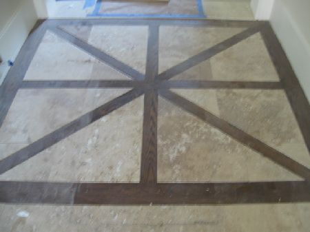 Antique parquet wood floor with a geometric border being refinished in a historic Houston home